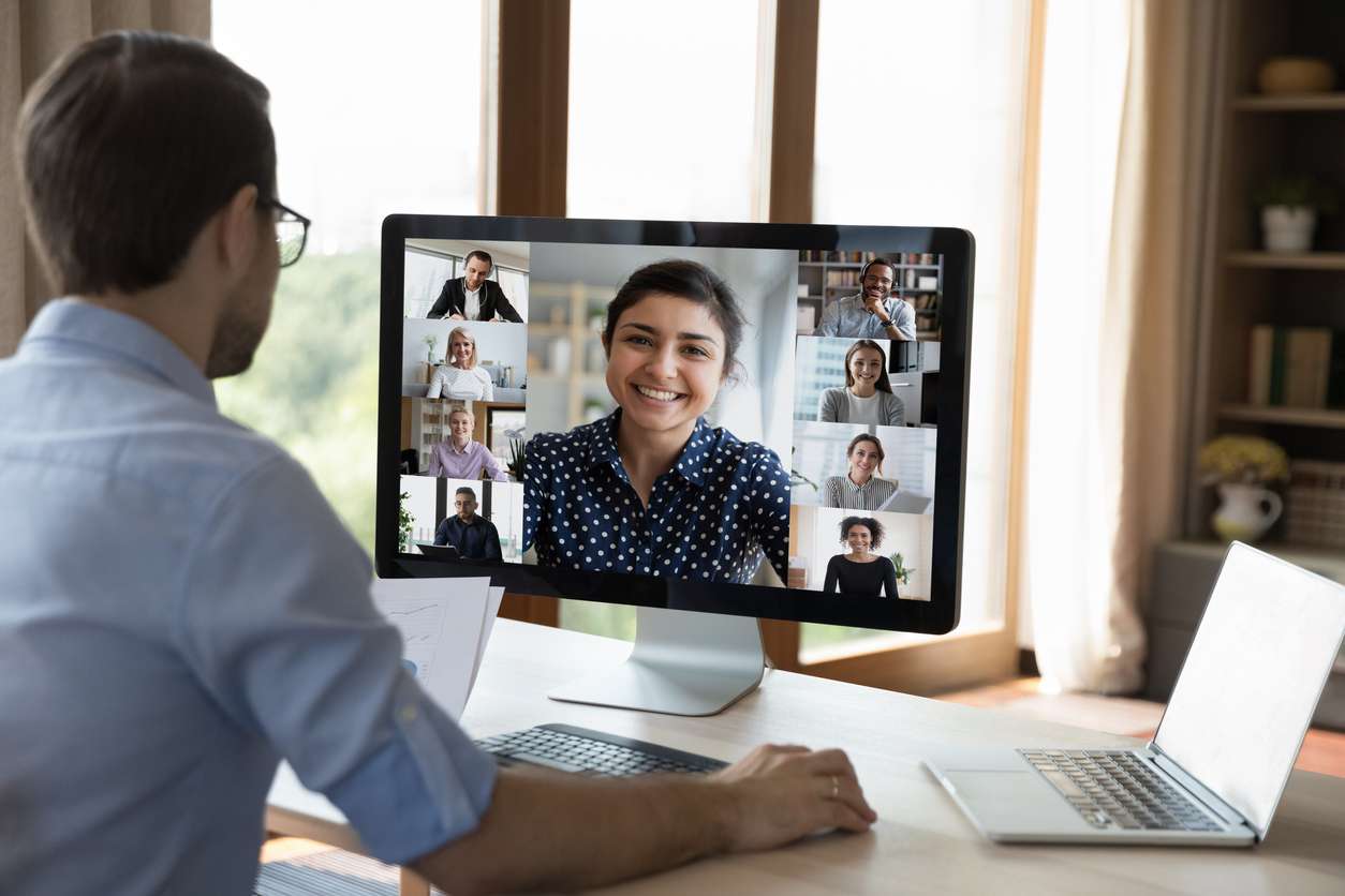 Man having a virtual meeting with colleagues showing employee culture in remote teams.