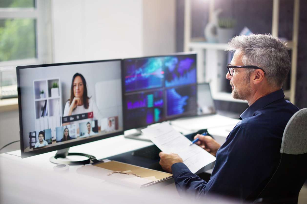 A businessman having a virtual meeting with his colleagues.