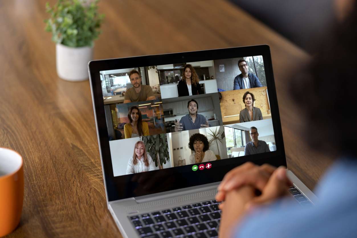 Business requirements for hiring - A businesswoman having a video conference meeting with her employees.