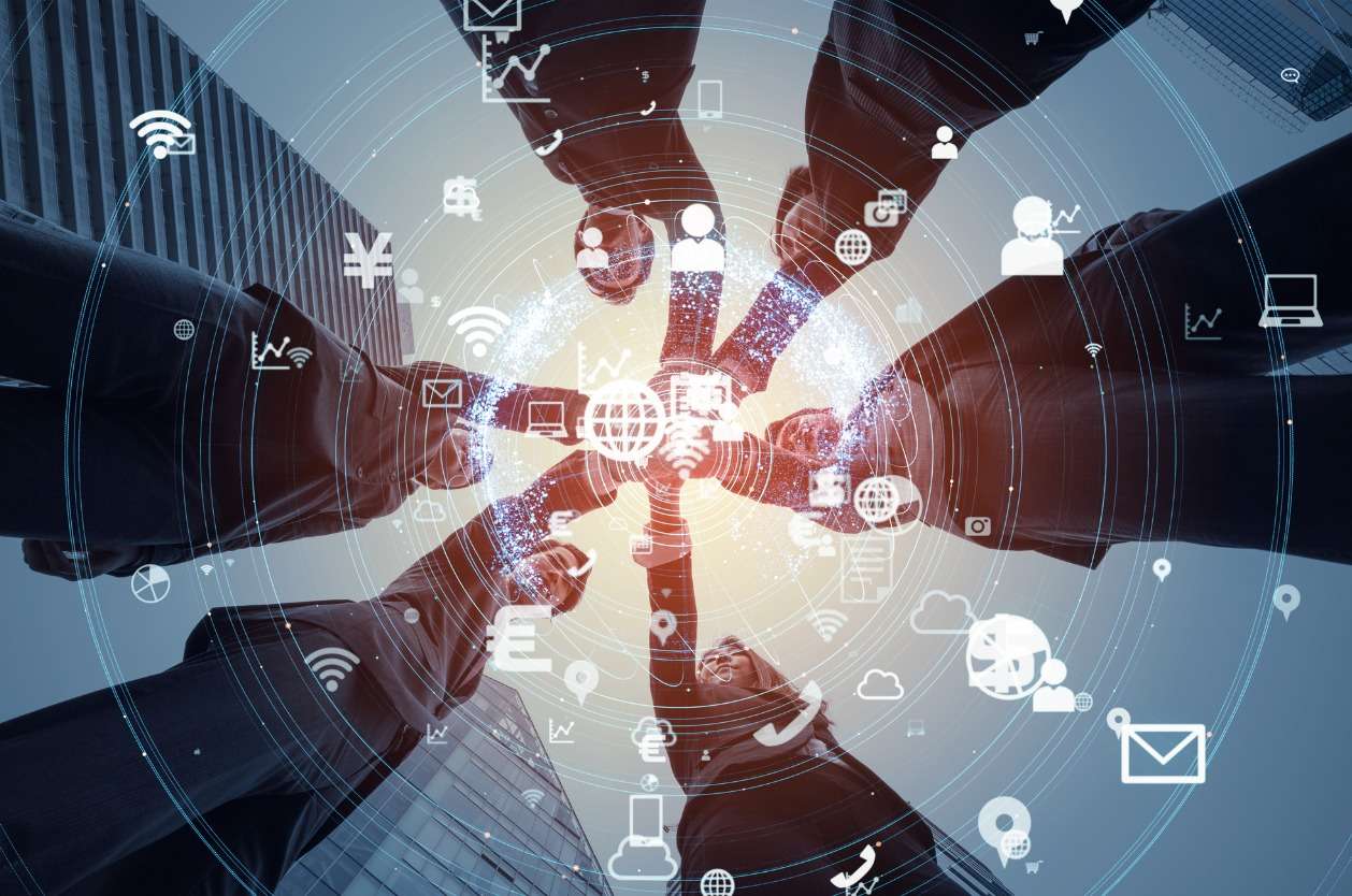 Streamlining global workforce management - A group of employees using technology to work and communicate with each other.