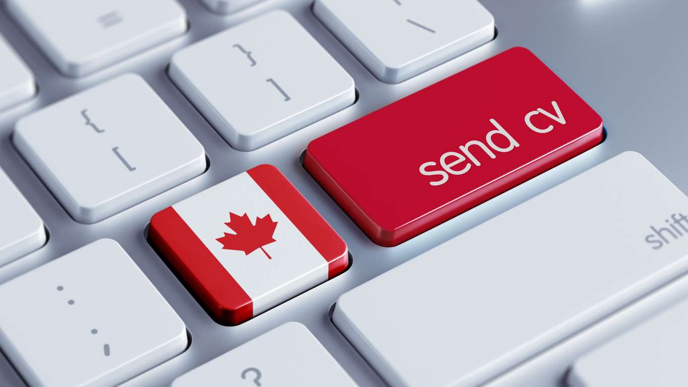 Computer keyboard with red "send"cv" keypad suggesting nearshore hiring in Canada.