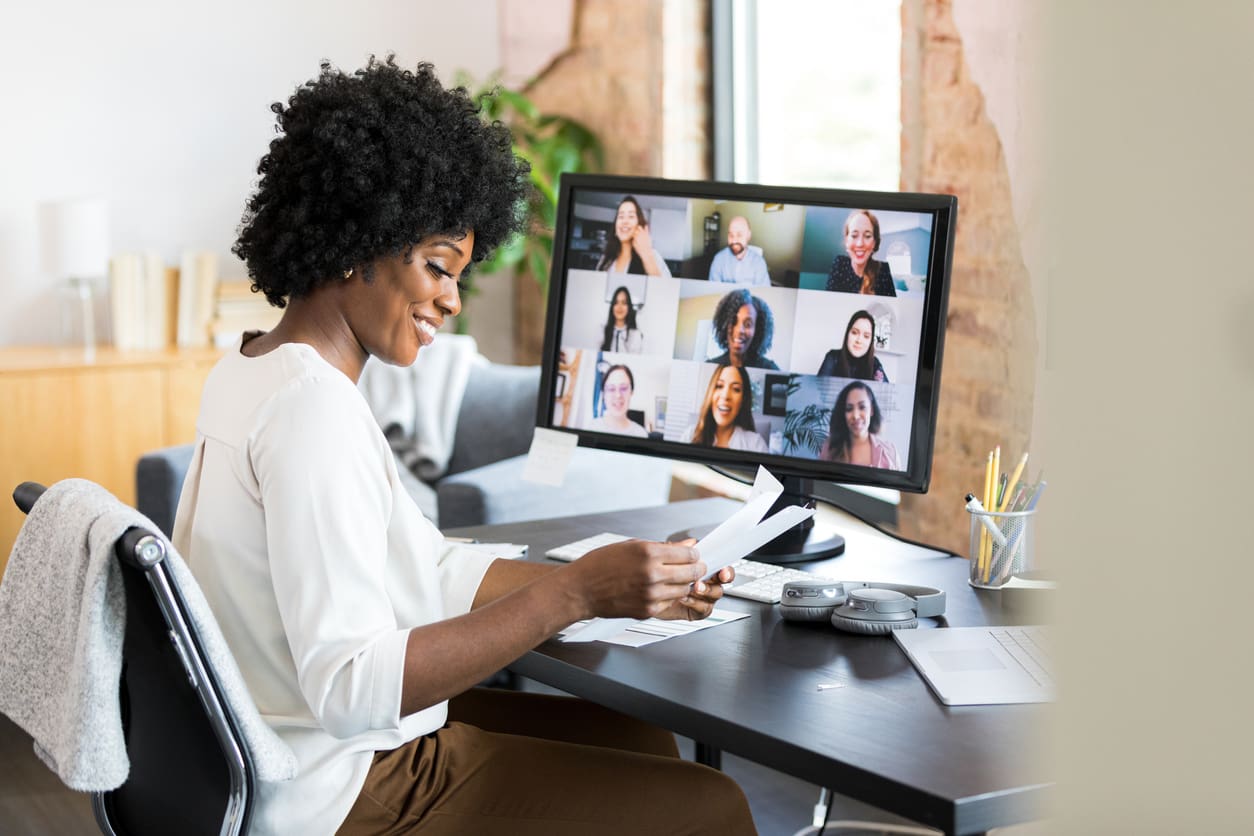 Diversity and inclusion benefits - A female employee working at home while having a meeting with her colleagues.