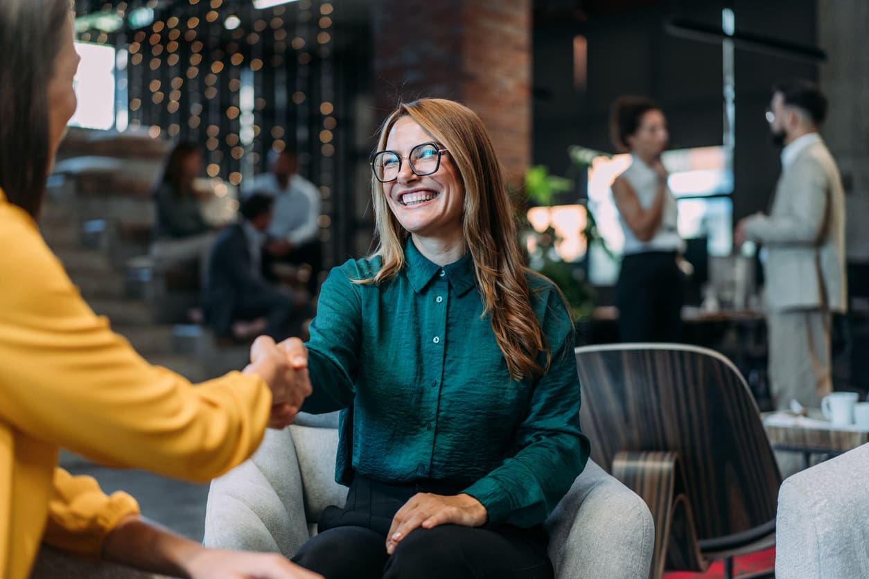 Hiring in Canada - A businesswoman shaking hands with a potential female employee.